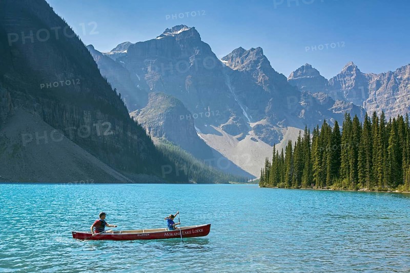 Tourists in canoe on Moraine Lake in the Valley of the Ten Peaks