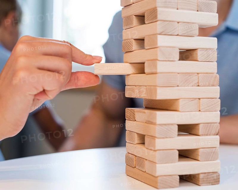 Close up family playing jenga together