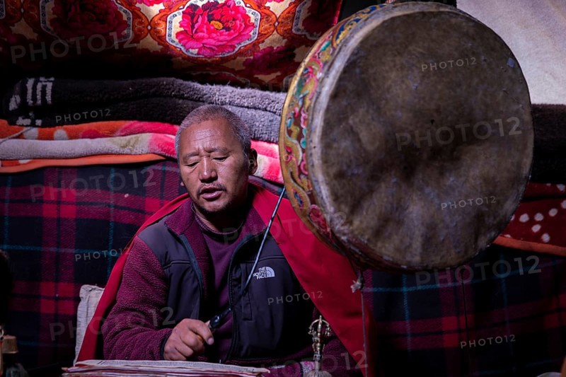 Buddhist monk performs puja in a nomadic tent