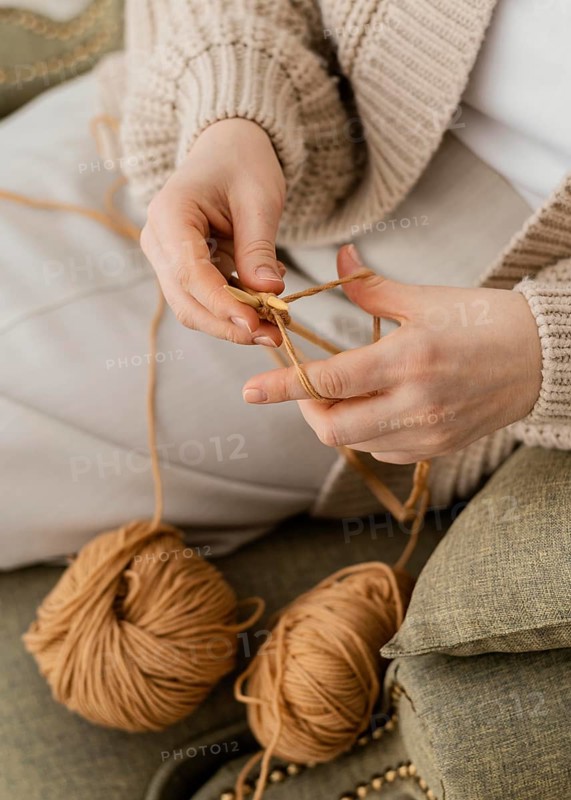 Close up hands knitting with yarn