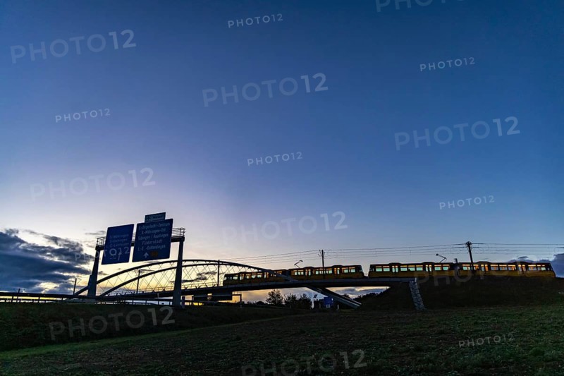 Network arch bridge over the A8 motorway. Light rail bridge of the SSB for the U6 airport line. The span of the arches is 80 metres. Tension elements made of carbon. The U6 line light rail bridge received the German Bridge Construction Award in 2023