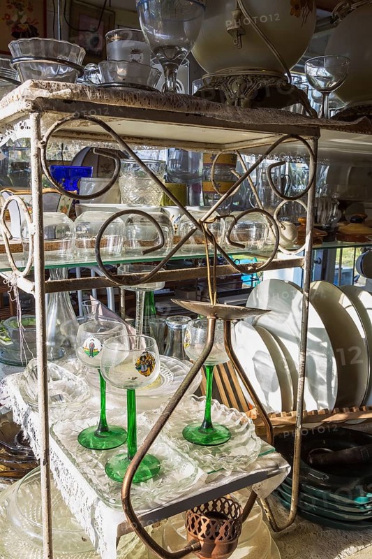 Old wine and liquor glasses for sale inside second hand goods and chattels store