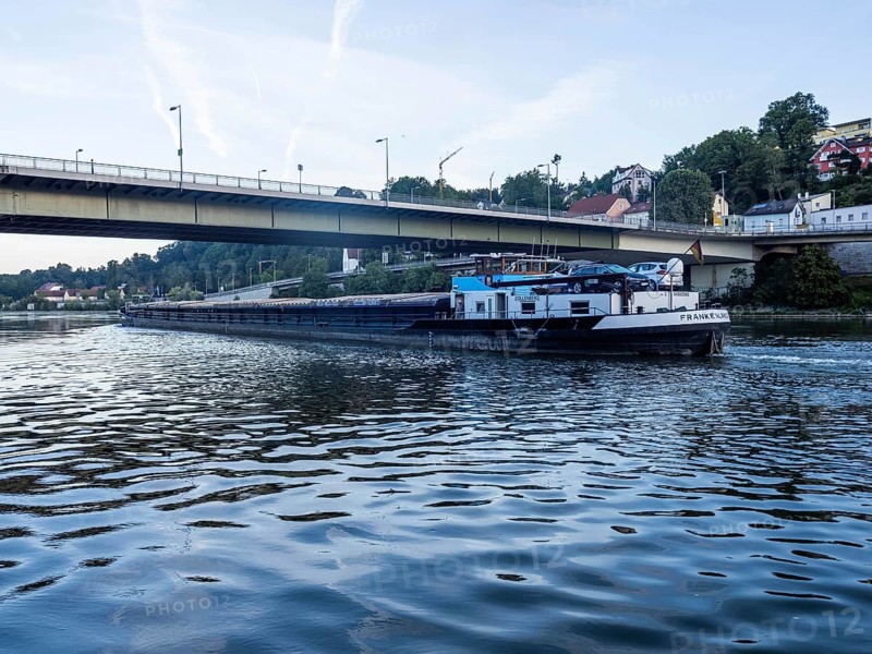 Cargo ship on the Danube under a bridge