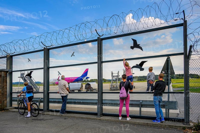 Spectators at the fence and Wizz Air Jet