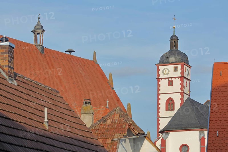 Tower of the baroque St. Augustine Church and roof of the town hall