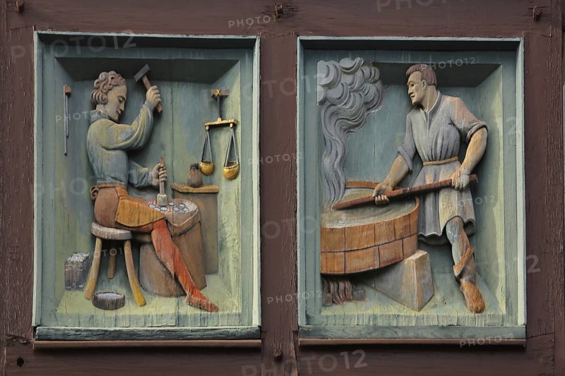 Relief with profession locksmith and blacksmith with figures