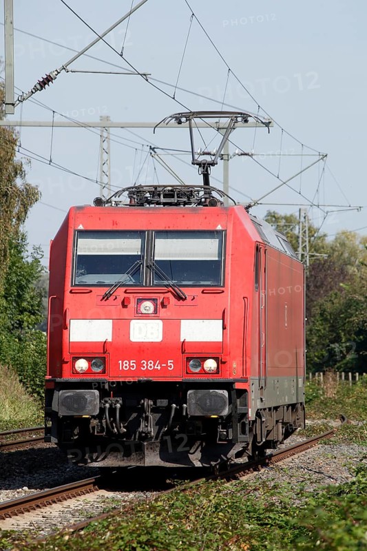 Red locomotive class 185 on a railway track