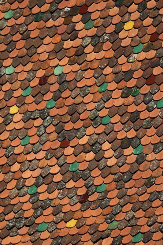Roof with colourful roof tiles from the bell tower