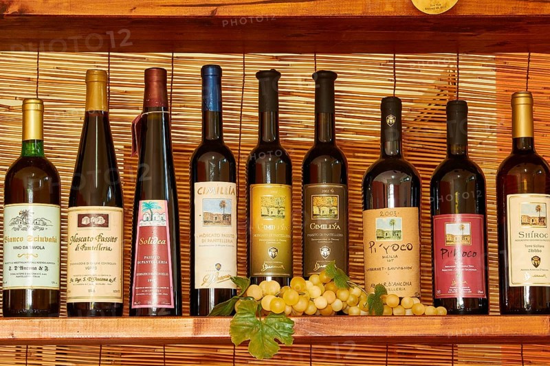 Different wine bottles on the shelf next to each other