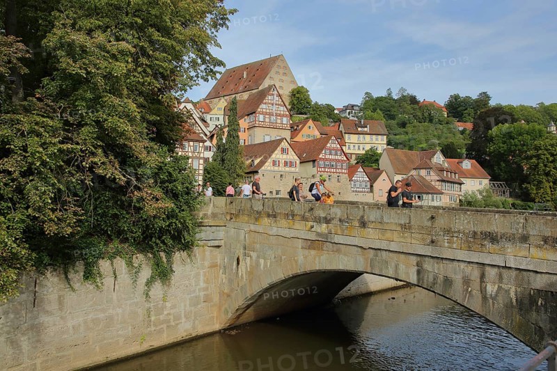 Stone arch bridge over the Kocher to the river island Unterwoehrd and cityscape with new building