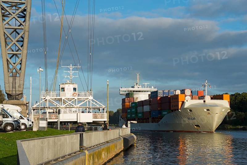 Suspended ferry and ship under the Rendsburg railway high bridge over the Kiel Canal