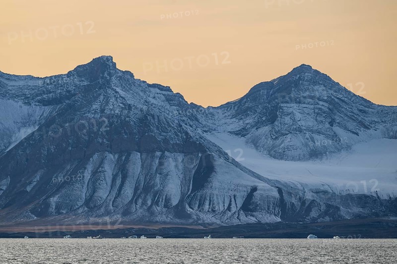 Icebergs in front of mountain range