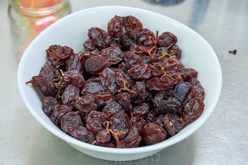 Dried dates in white porcelain bowl