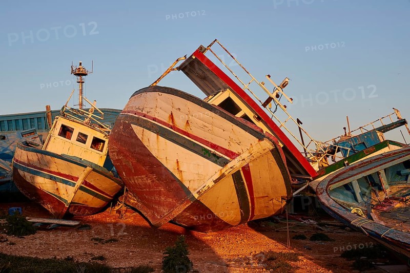 Larger cabin boat lying on its side