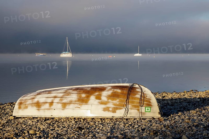 Fog over Lake Constance on an autumn morning with boats