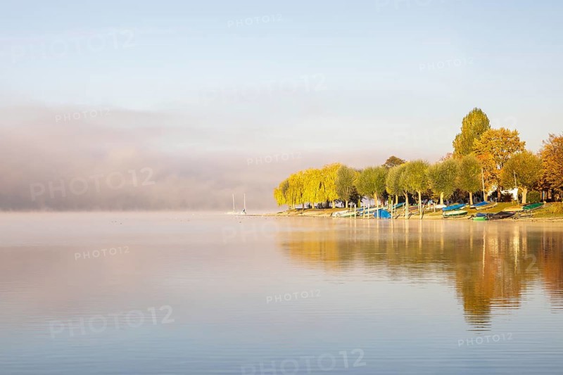 Fog over Lake Constance on an autumn morning with boats