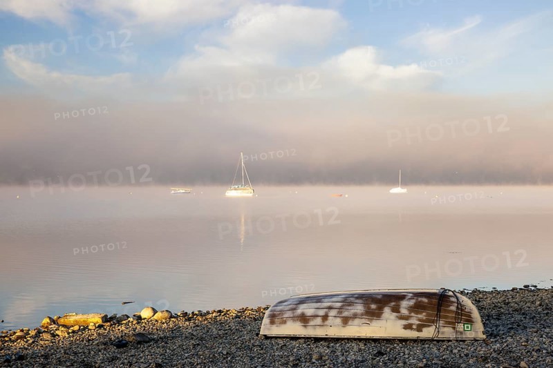 Fog over Lake Constance on an autumn morning with boats