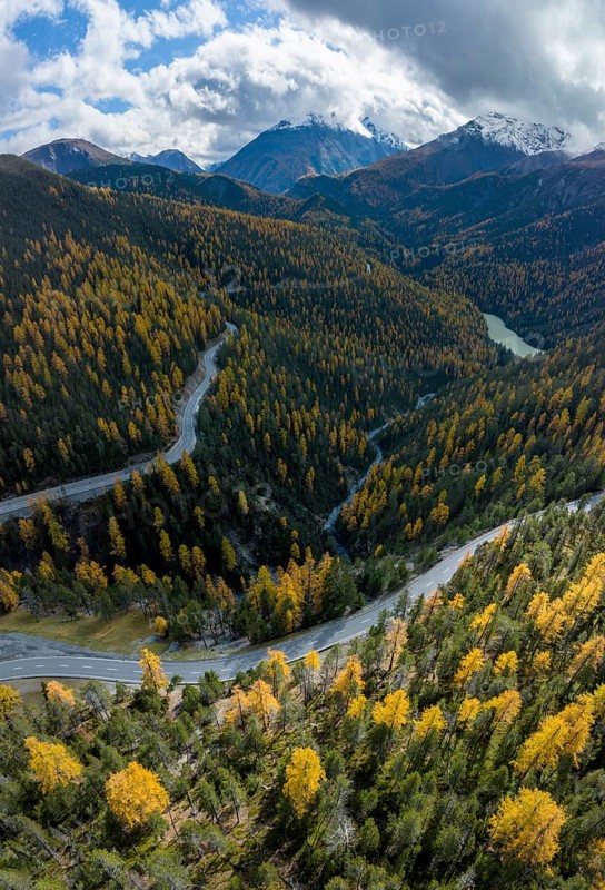 Colourful autumn landscape with a view of the Swiss National Park and the Lai dad Ova Spin reservoir