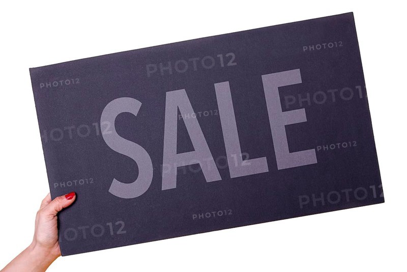 Woman hand holding a SALE black poster on transparent background. Studio shot. Commercial concept