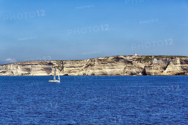 Sailboat in front of white chalk cliffs