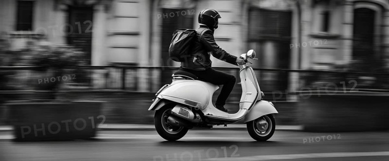 Italian elegant man wearing suit and tie driving moped vintage scooter in Rome Italy at sunset traditional urban scene