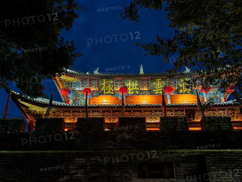Old Chinese city gate with illuminated roofs