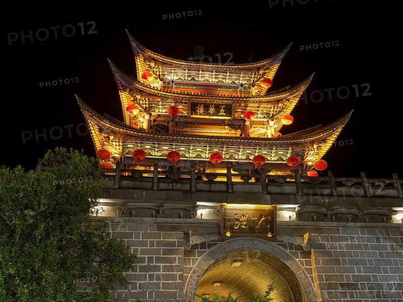 Old Chinese city gate with illuminated roofs