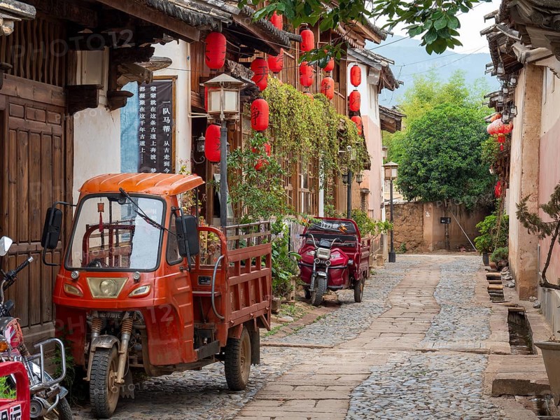 Ancient Chinese houses and tricycle car in the alleys of Shaxi
