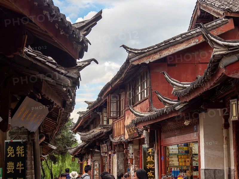 Alleys with old Chinese wooden houses and strolling passers-by