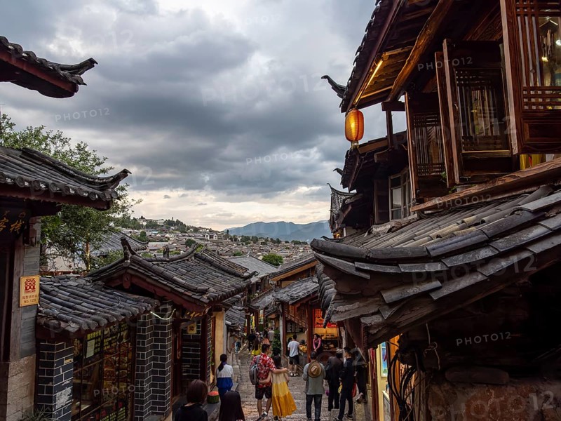 Alleys with old Chinese wooden houses and strolling passers-by