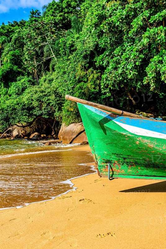 Rustic rowing canoe used for fishing on a paradisiacal beach and desert on Ilha Grande in Angra dos Reis
