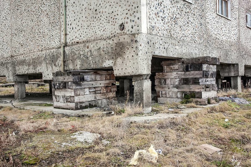 Pallets support a residential building that is in danger of sinking due to the thawing permafrost
