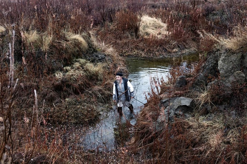 Scientist Sergei Zimov examines a varnish in an area where permafrost is rapidly thawing