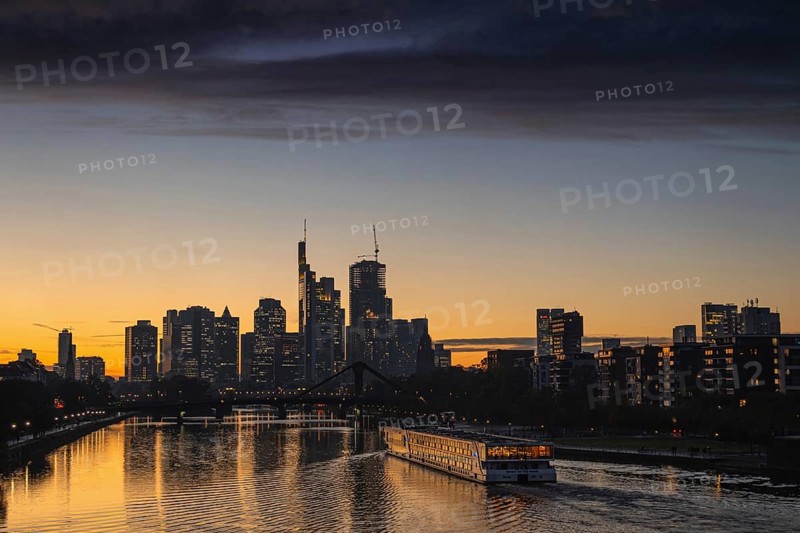 A dense band of clouds passes over Frankfurt's banking skyline in the evening shortly after sunset