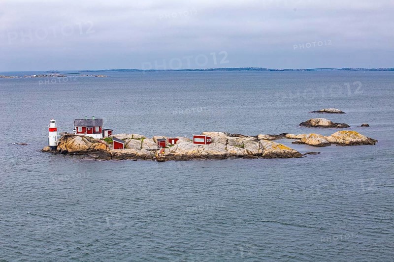 Typical tiny archipelago island with lighthouse and lighthouse keeper's house
