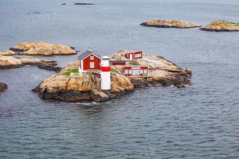 Typical tiny archipelago island with lighthouse and lighthouse keeper's house