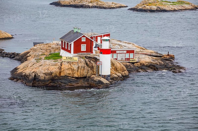 Typical tiny archipelago island with lighthouse and lighthouse keeper's house