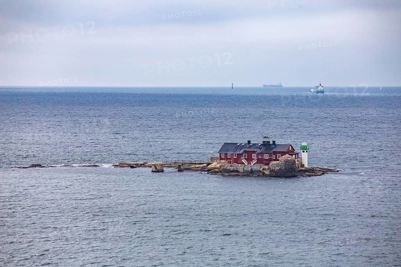 Typical tiny archipelago island with lighthouse and lighthouse keeper's house