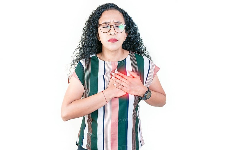 Afro woman with heart pain touching chest isolated. Afro girl with tachycardia. People with heart problems