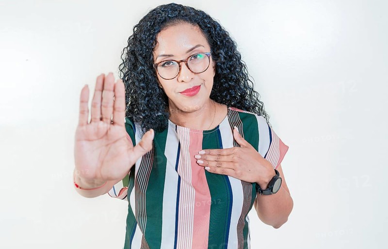 Afro girl gesturing stop isolated. Latin girl gesturing stop with palm hand isolated. Young afro woman rejecting with the palm hand isolated