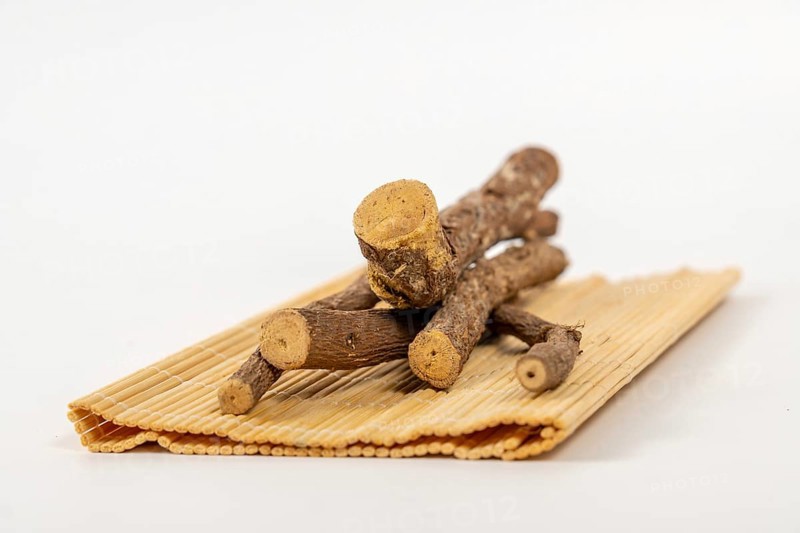 Pile of licorice roots sticks isolated on a white background