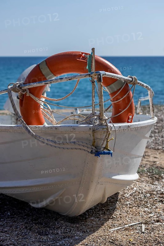 Boat with life belt on the beach