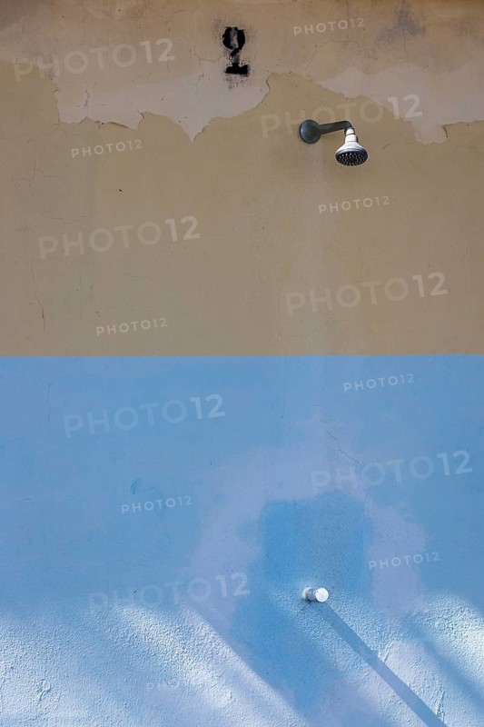 Shower on a weathered wall on the beach