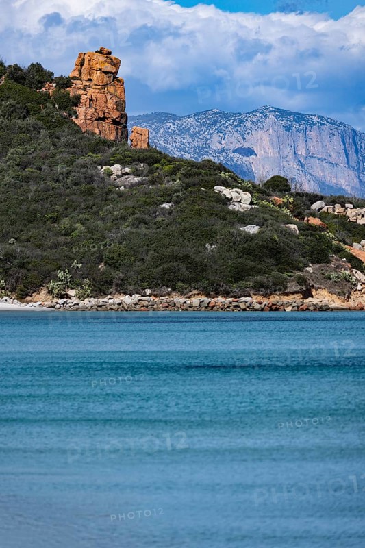 Landscape with red rocks and bright blue sea