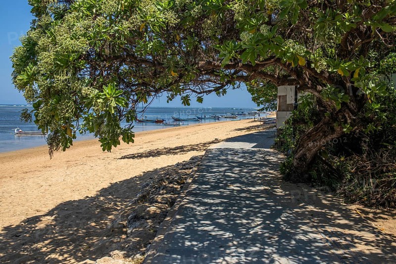 Sunrise on the sandy beach. Landscape shot with a view of the sea and the beach. Waves of light and a morning atmosphere that only exists in Sanur