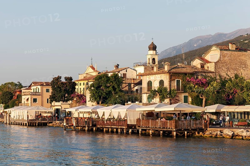 Lake shore with restaurant terraces and historic old town