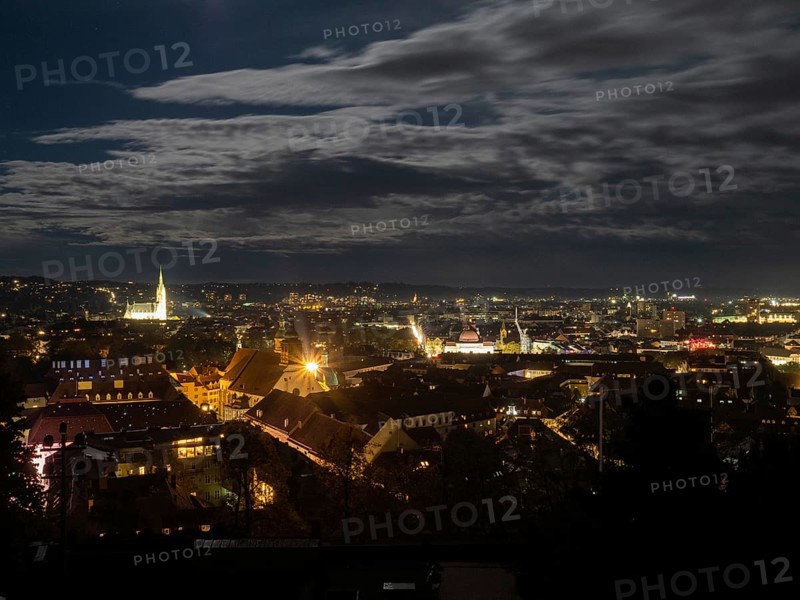 View of the city of Graz illuminated at night from the Schlossberg