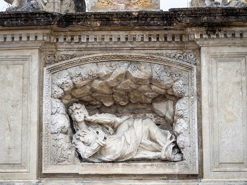 Reclining figure of a saint