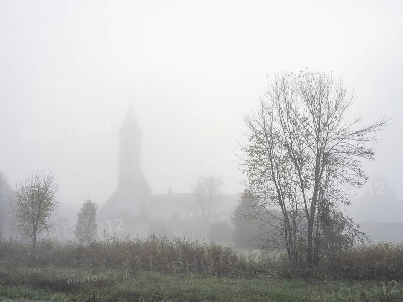 Church tower in the morning mist