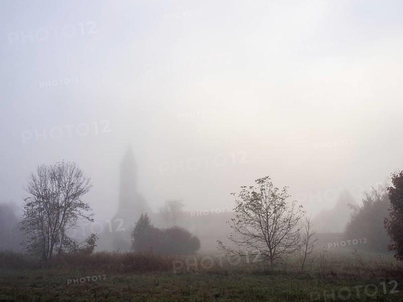 Church tower in the morning mist